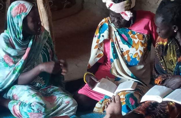 Photo of women studying the Bible in a home