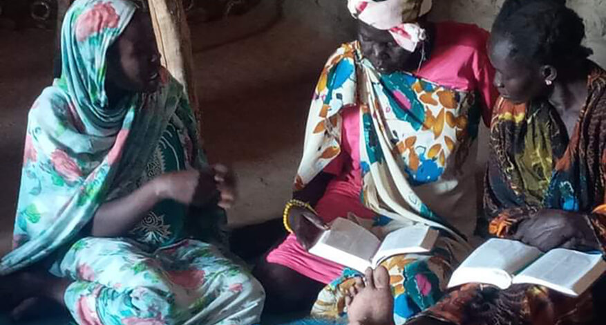 Photo of women studying the Bible in a home