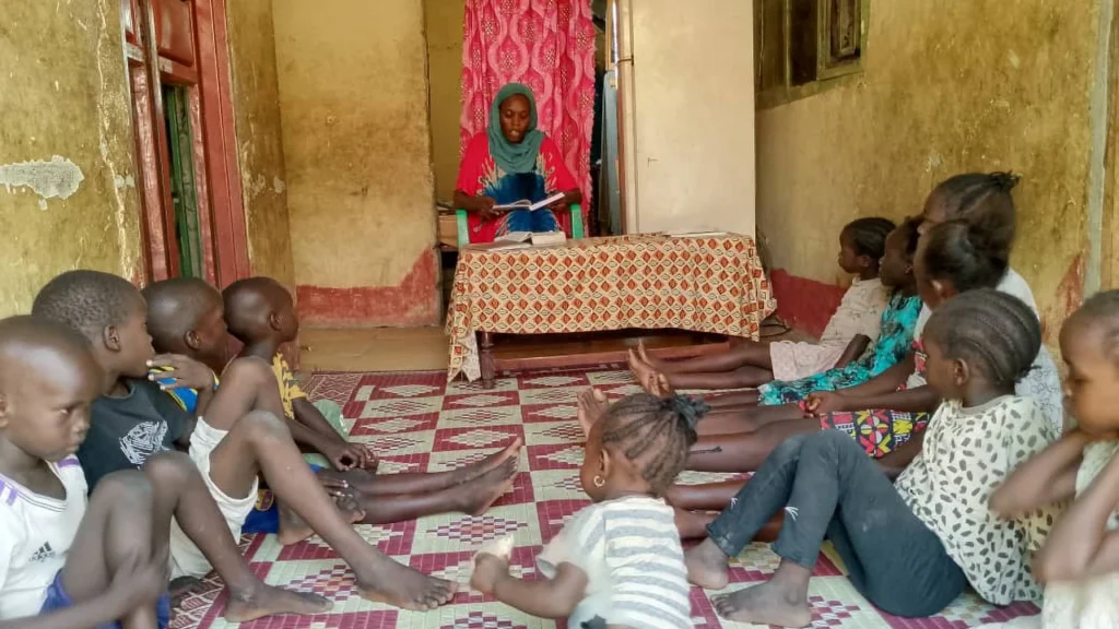 Khamisa teaching children in her home